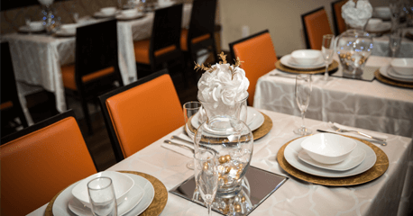 Host in Style – Stunning Event Decor & Catering Services Elegant dinner party setup with professionally decorated tables and fine dining service