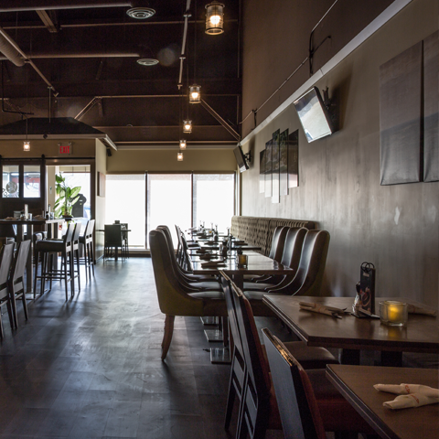 Click to view full image of Xaymaca’s elegant dining space Warm and inviting restaurant interior with dimmed lighting – thumbnail view